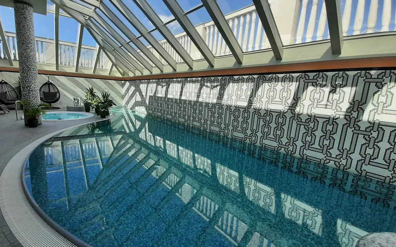 Al Habtoor Palace Budapest indoor pool under a glass roof near the thermal baths in Budapest, Hungary