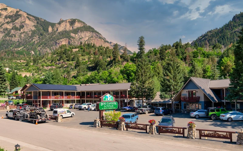 Redwood hot tubs terraced up the hillside at Box Canyon Lodge, a hot springs hotel in Ouray, Colorado