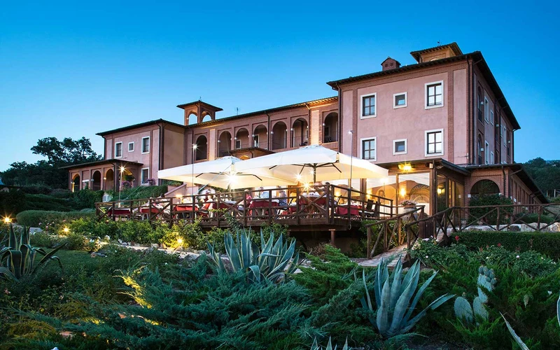 Infinity pool and hillside rooms at Saturnia Tuscany Hotel near the Saturnia hot springs in Tuscany